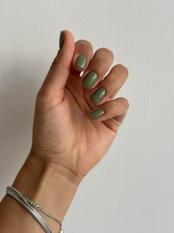 Rounded nails in a muted sage green