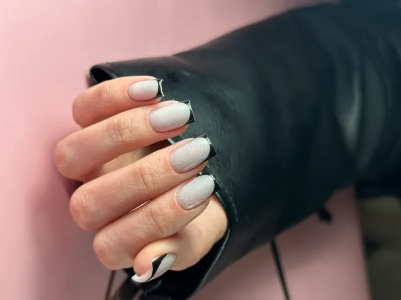 Square nails in silver shimmer with black French tips